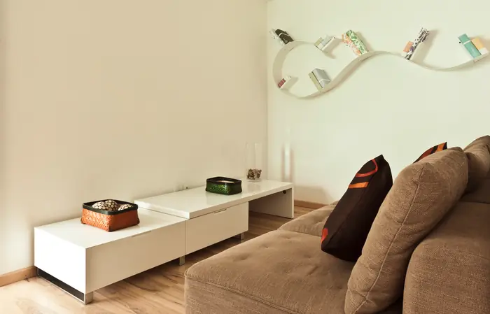 Estancia con sofá café y mueble blanco