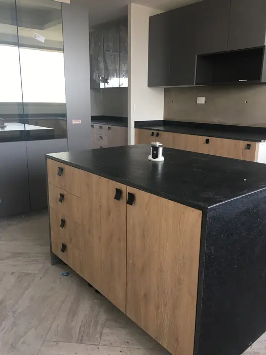Isla de cocina en madera con cubierta de granito negro